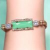 Multilayer golden bracelet with green mint stone